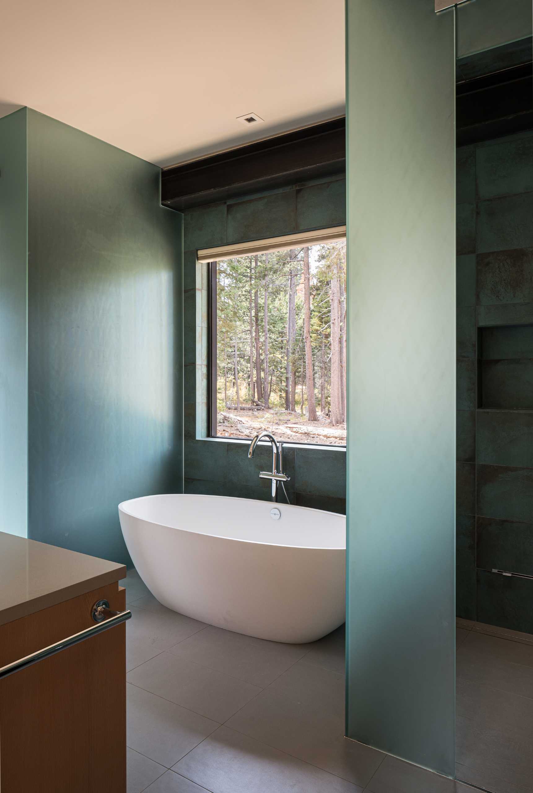 In the bathroom, a freestanding bathtub is positioned below the window.