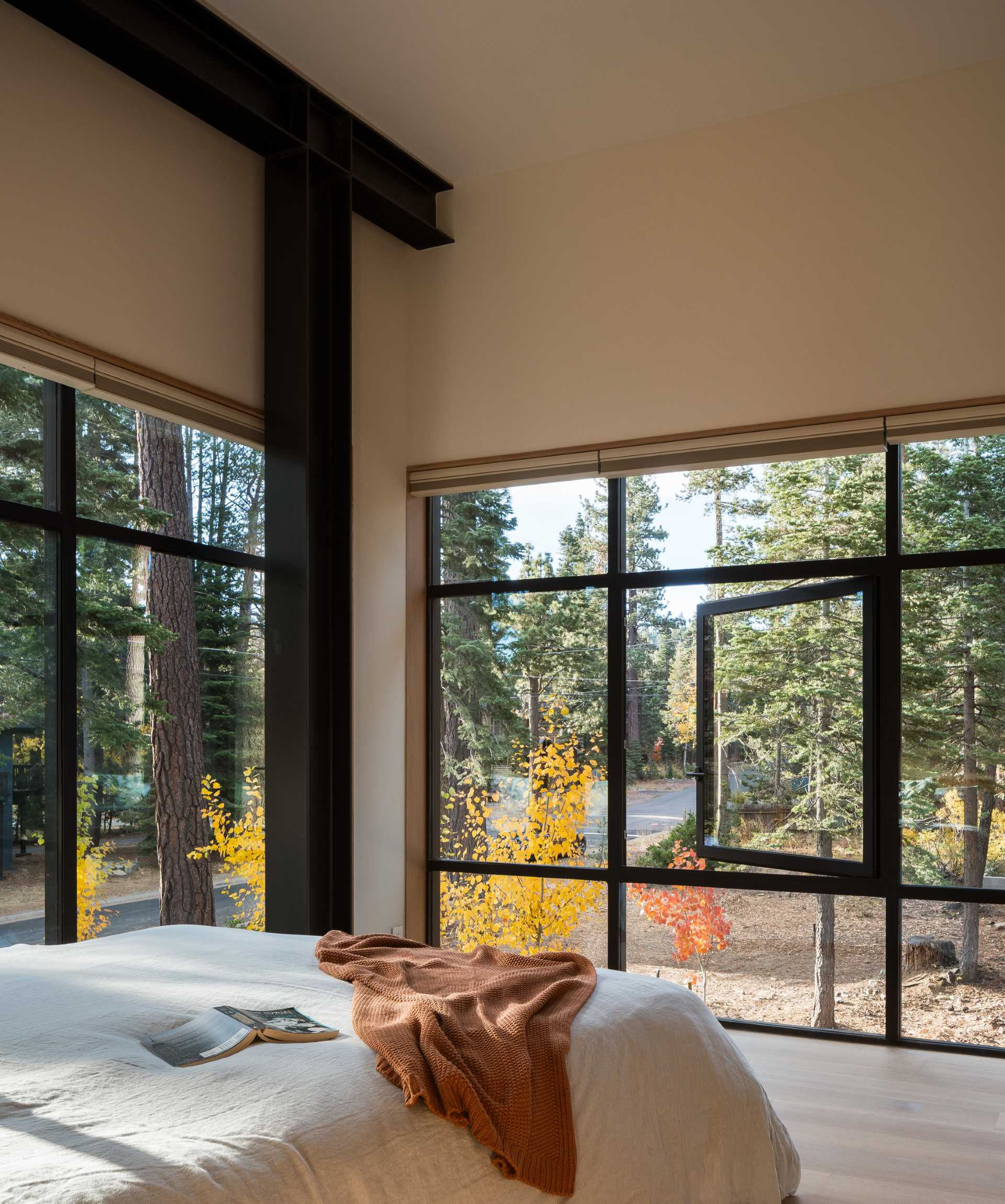 In this modern bedroom, the steel beams are on display and complement the black window frames.