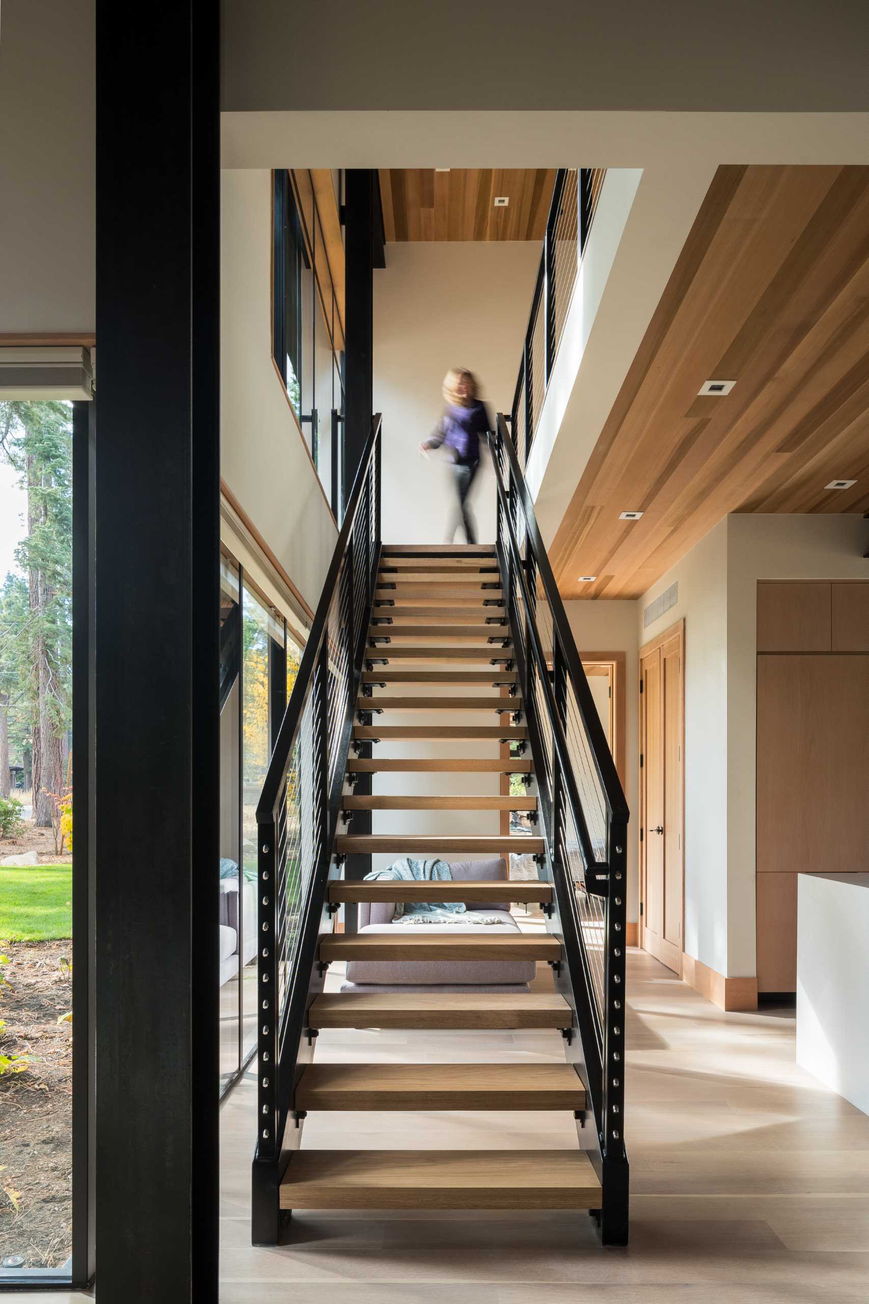 Steel and wood stairs lead to the upper floor of the home.