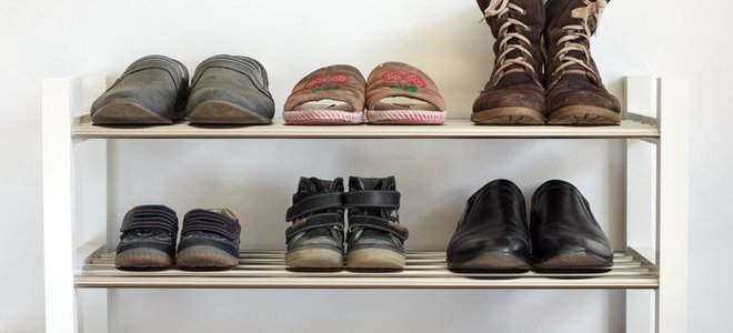 A shoe rack with shoes on them. 