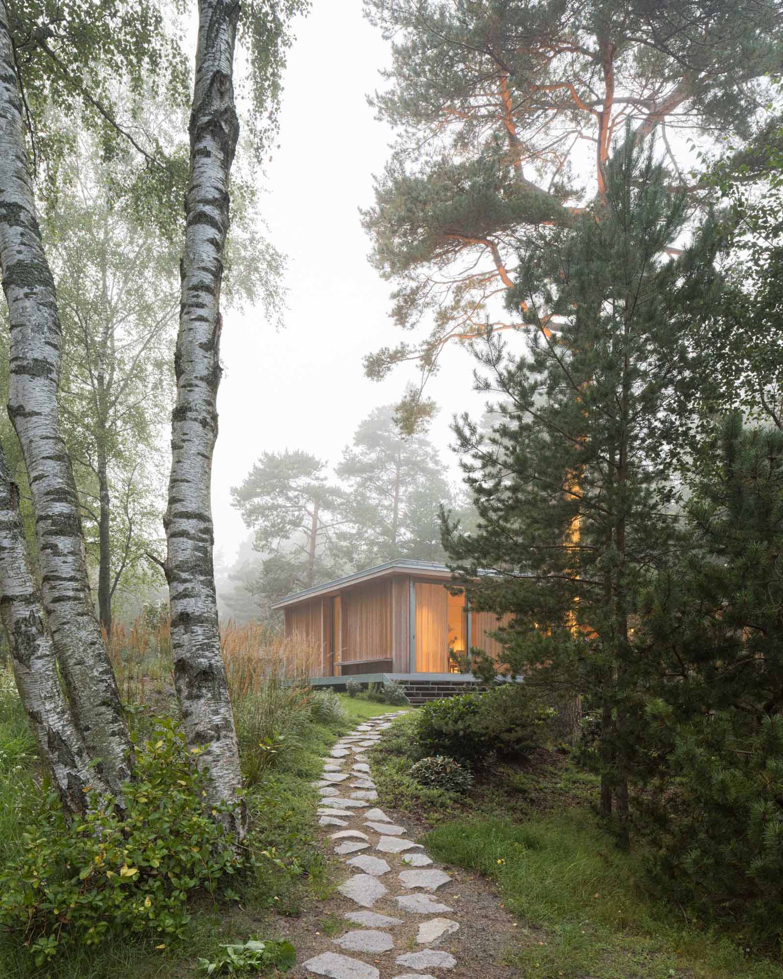 An elevated summer home clad in larch wood.