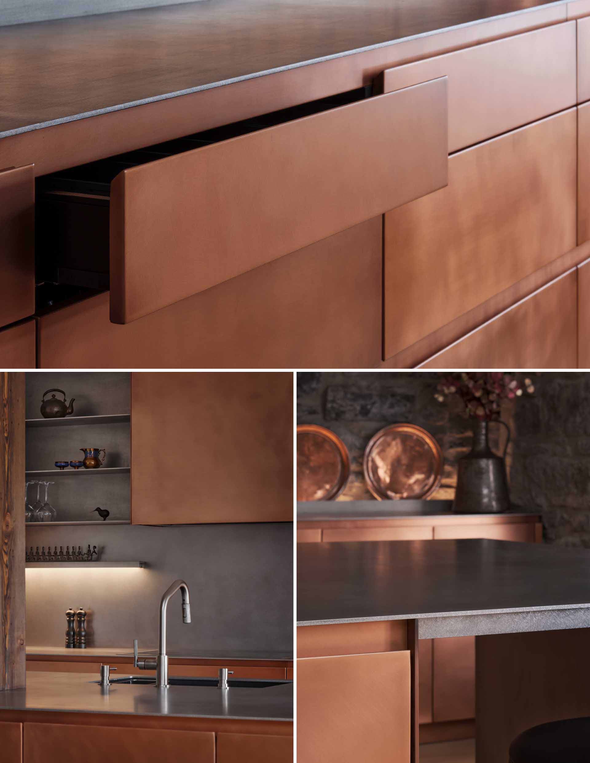 This modern kitchen in a renovated historic loft, features striking copper cabinetry and a stainless steel countertop.