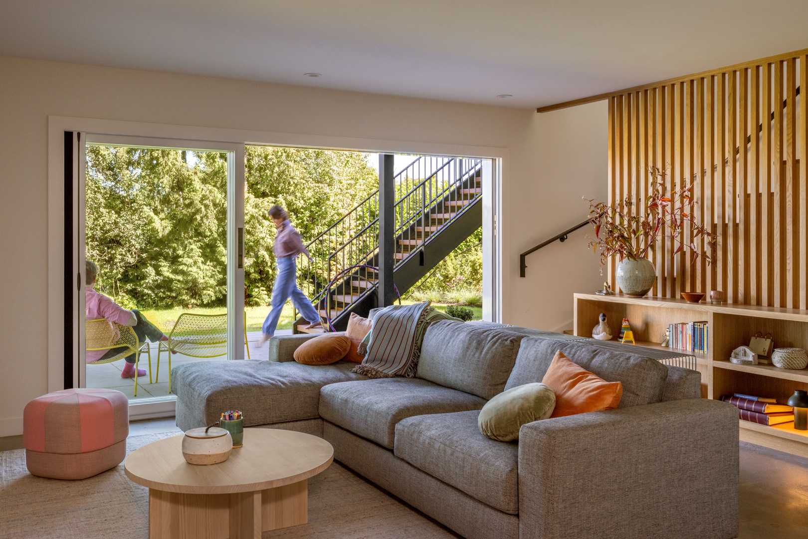 A updated interior with wood stairs, built-in shelving, and living room.