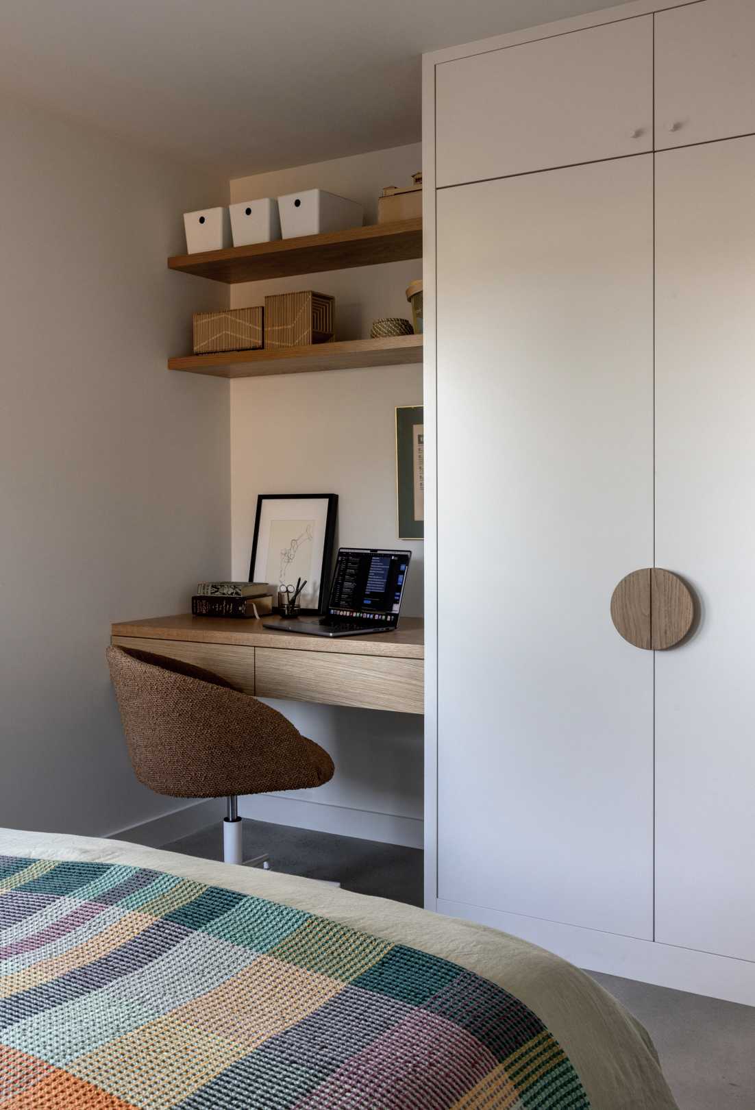A contemporary bedroom with a built-in desk.
