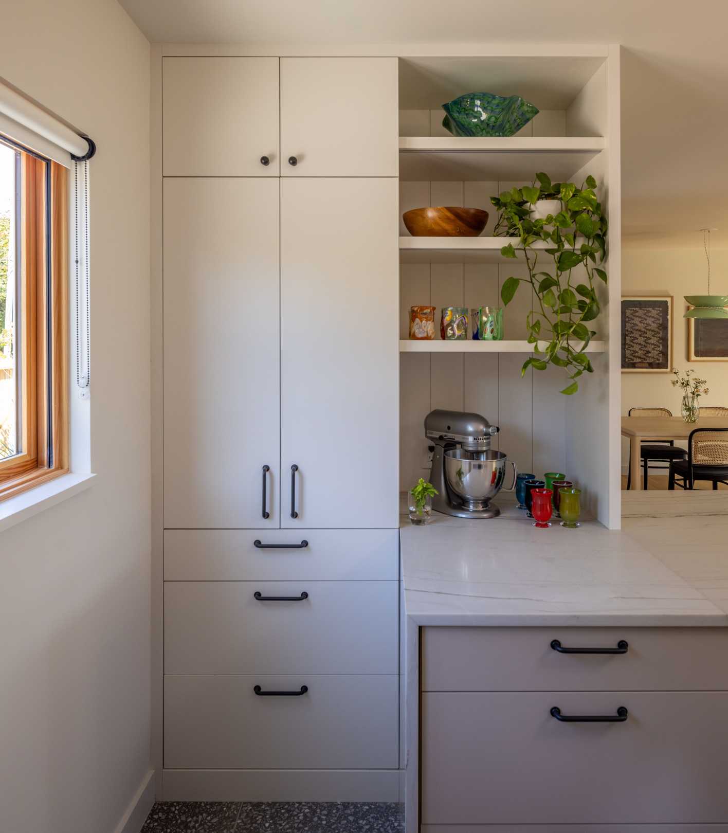 This new kitchen features a functional “U” shape with natural stone countertops, offering seamless access to the dining and living areas for a connected main floor experience.