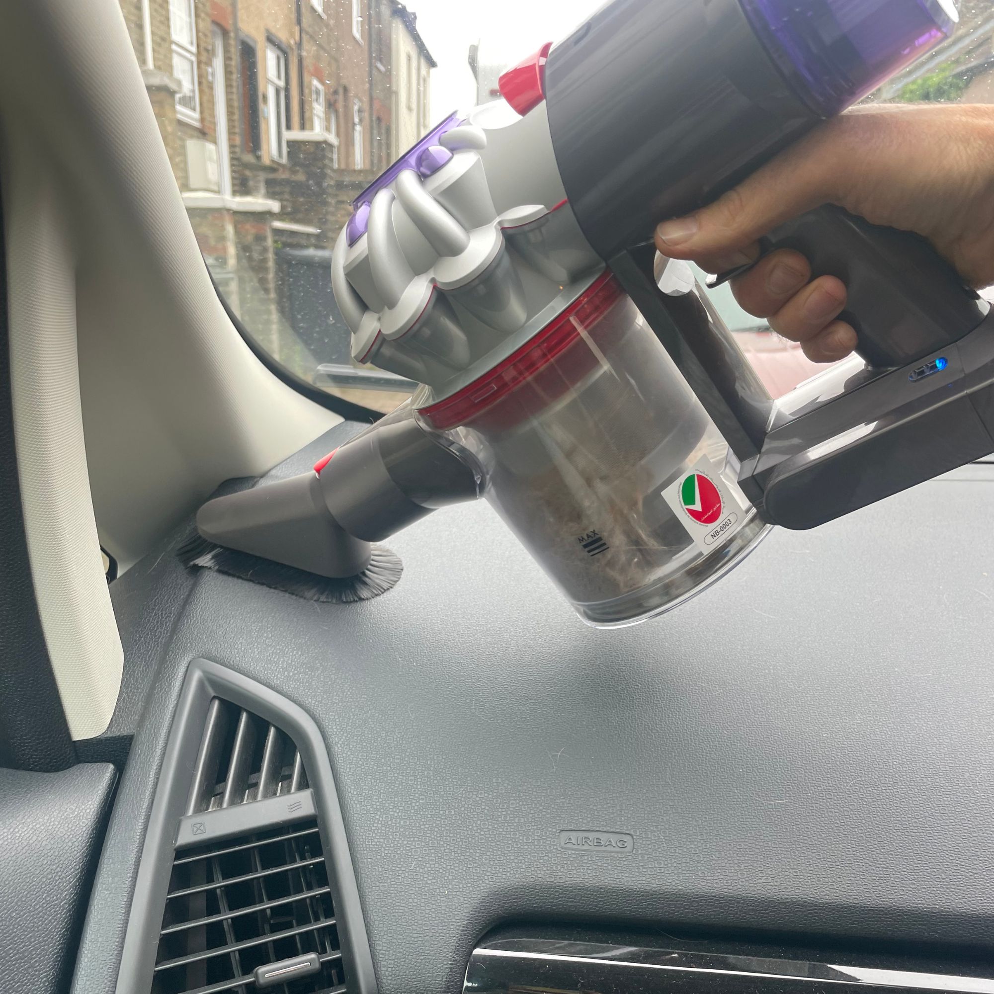 Using the Dyson soft cleaning tool in a car