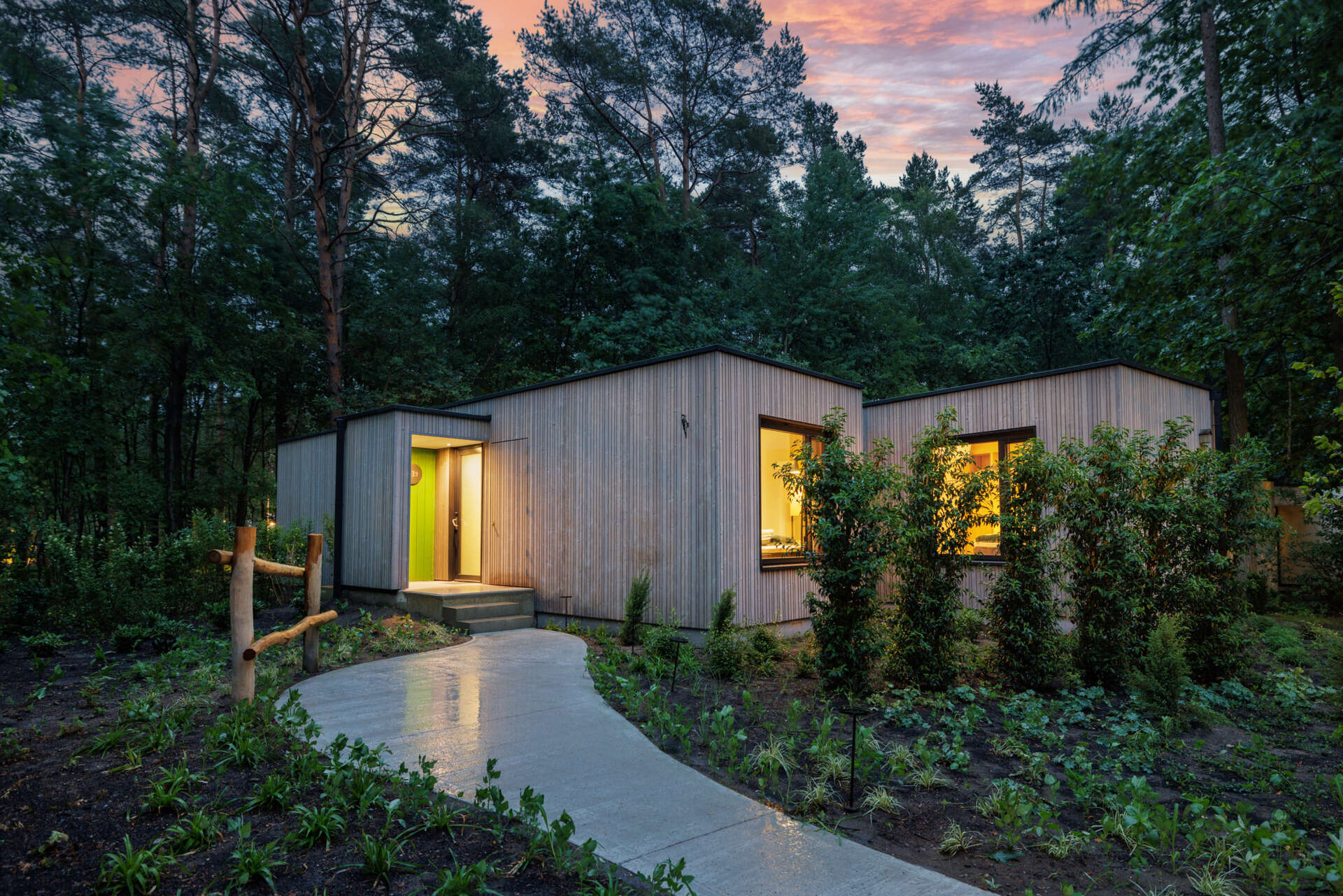 Step inside a modern prefab cottage where minimalist design and natural materials create a serene forest escape.