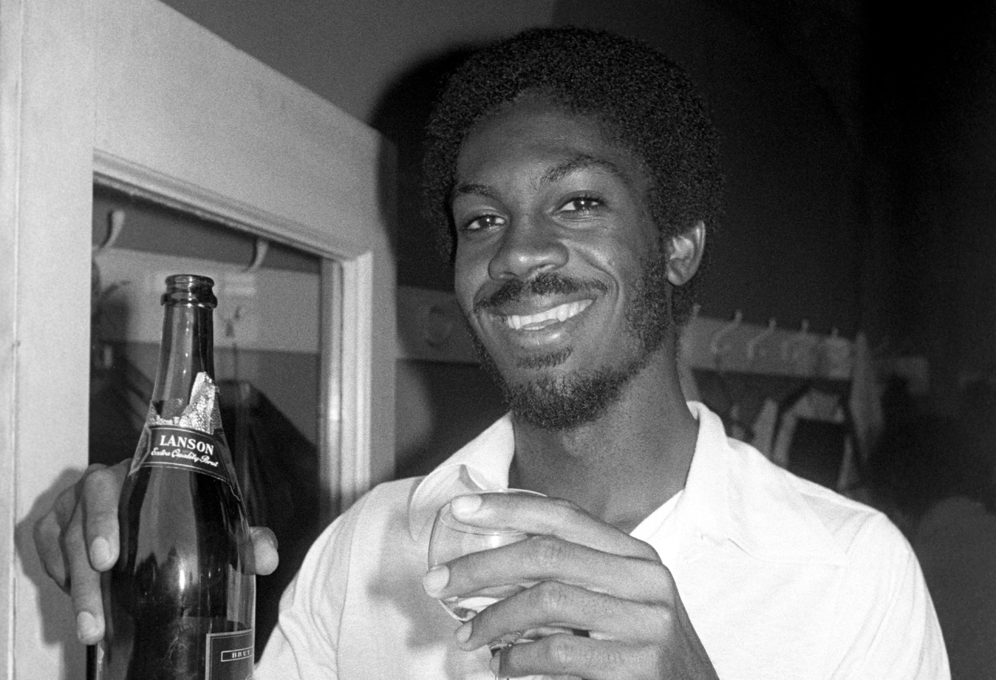 Champagne celebration for Michael Holding in the West Indies' changing room. He had just cause to celebrate for he took his 14th wicket (a then record for a West Indies bowler in a Test Match) to help the West Indies beat England by 231 runs, thus winning the series. (Photo by PA Images via Getty Images)