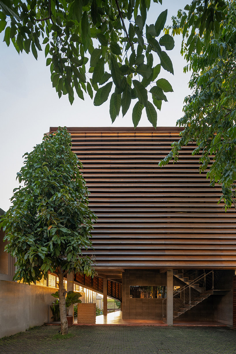 restaurant by studio kota cascades down balinese terrain in a series of open-air platforms
