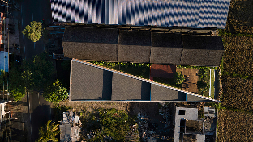 restaurant by studio kota cascades down balinese terrain in a series of open-air platforms