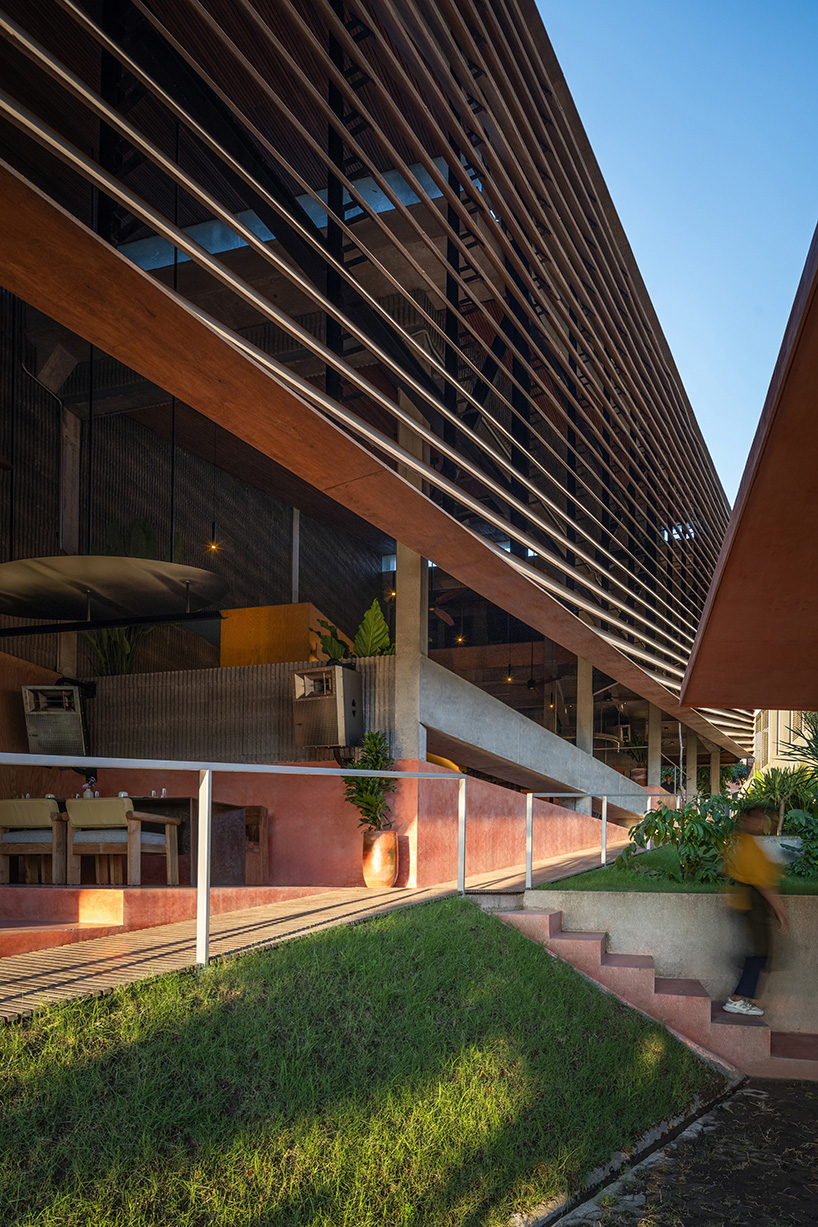 restaurant by studio kota cascades down balinese terrain in a series of open-air platforms