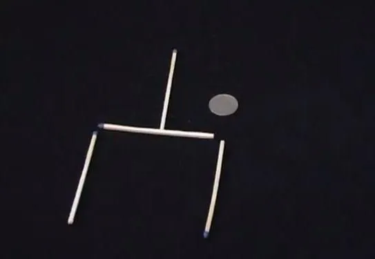 A geometric arrangement of sticks and a circle on a dark background.