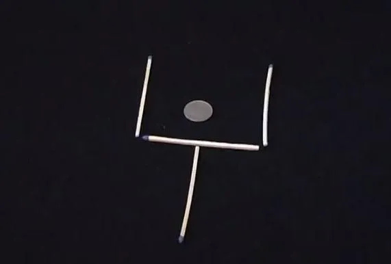 Matchsticks arranged in a square with a circle in the center.