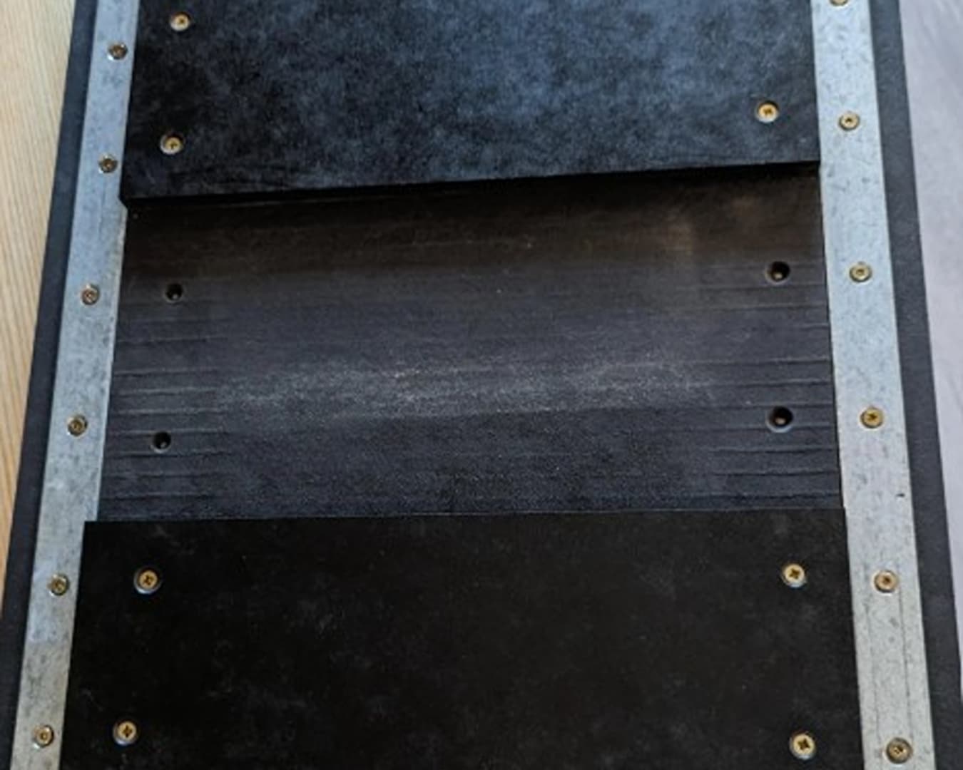 metal strips to the back of the cable panel and magnets to the wall to hold the panel in place