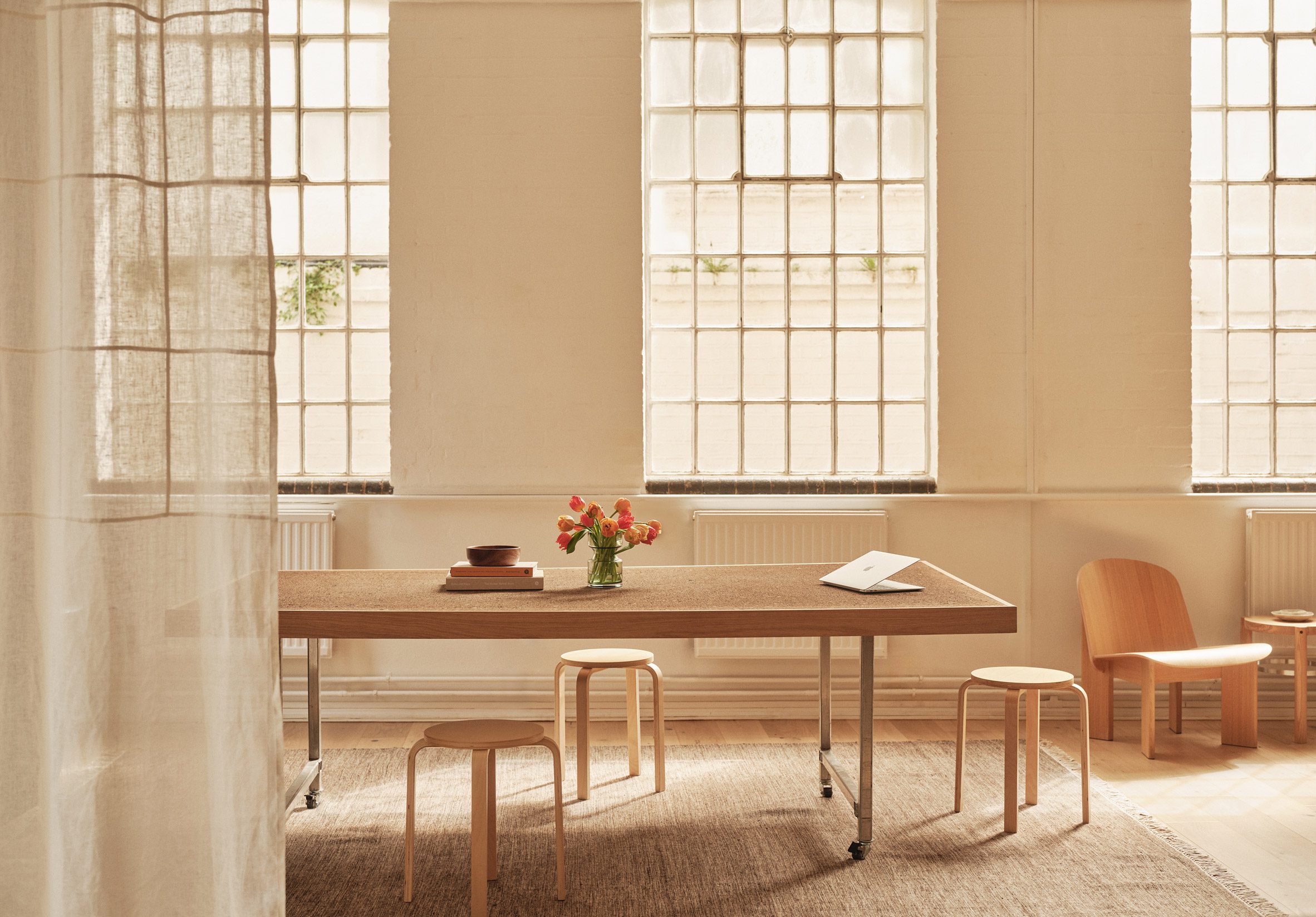Neutral workspace with large factory windows