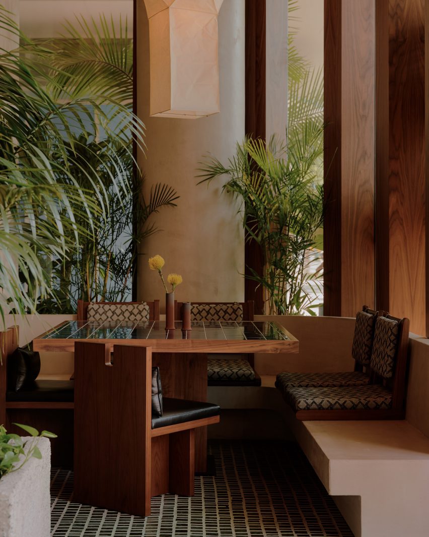 Seating booth with green tiles on the floor and table top