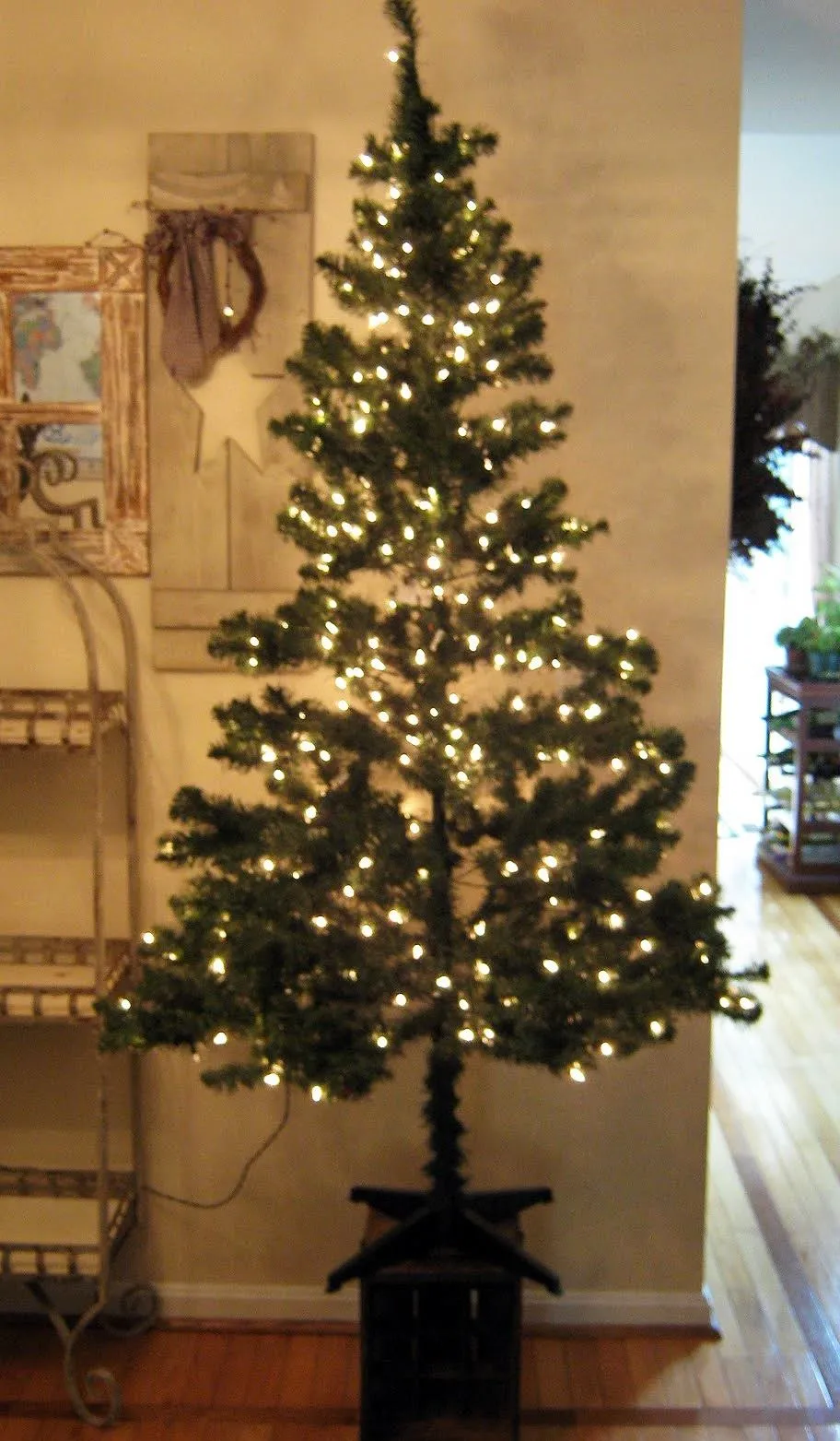 Artificial Christmas tree decorated with white lights.