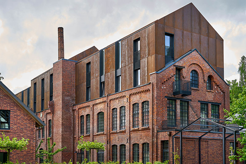 corten steel extends former laundry complex’s brick buildings in kassel