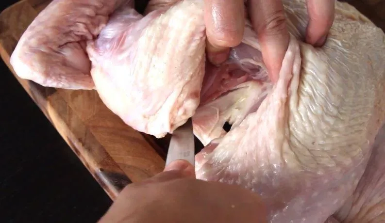 Raw chicken being prepared for cooking.