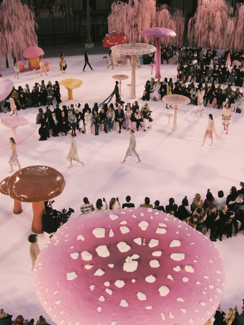 giant mushrooms populate dreamlike forest set inside the grand palais for chanel show