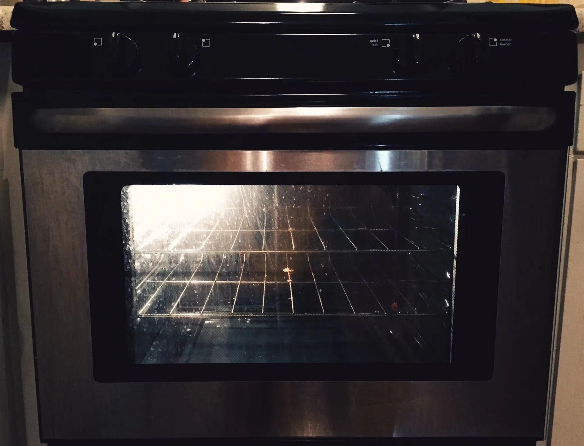 Black kitchen oven with a glass door and visible interior racks.