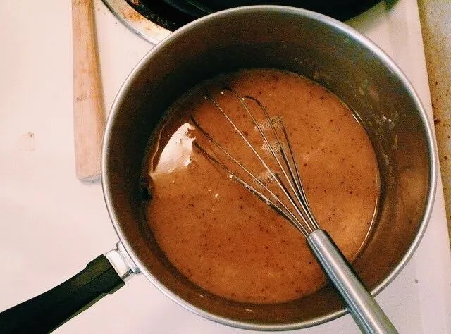 Whisk in a saucepan with a creamy mixture.