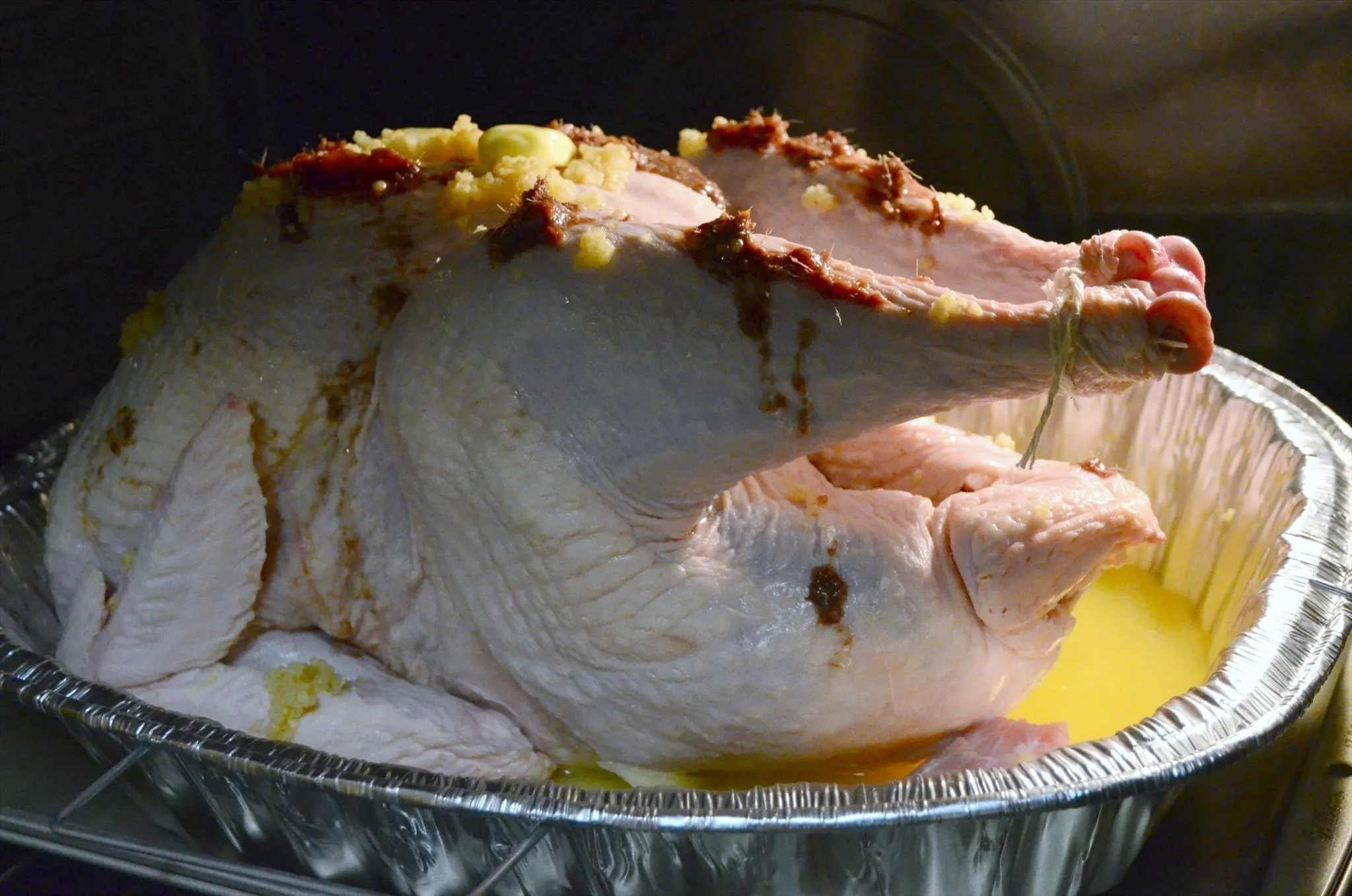 Roasted turkey in a silver cooking tray.