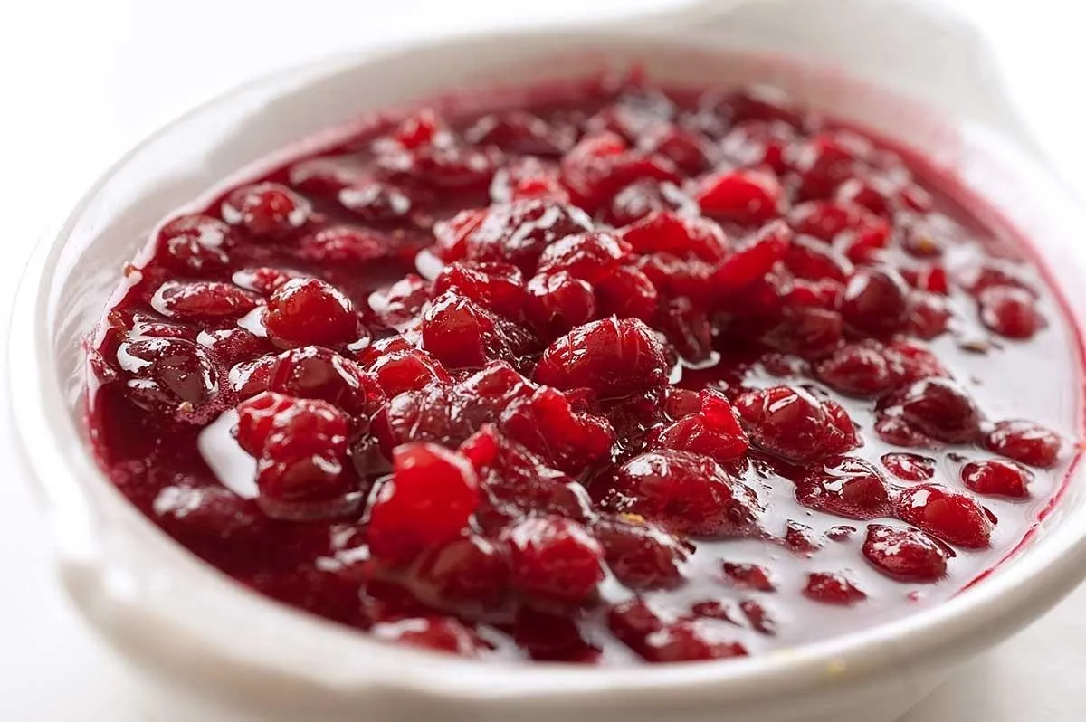 Cranberry sauce in a white serving dish.