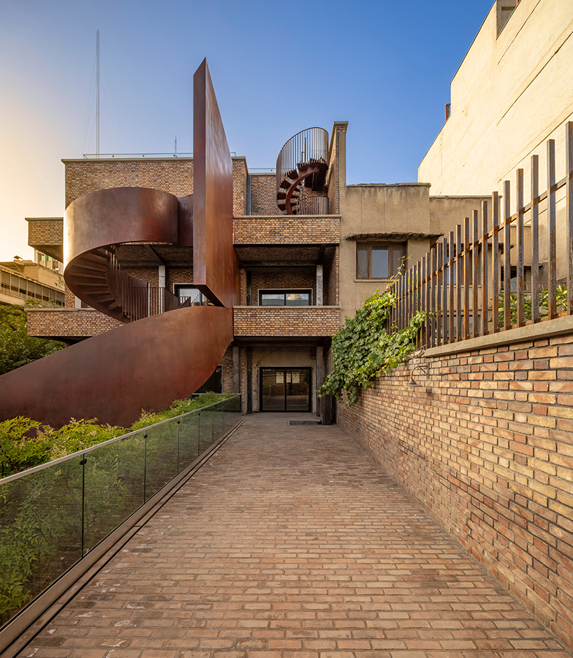 sculptural steel staircase and wall breathes new life into iranian poet’s 1970s home