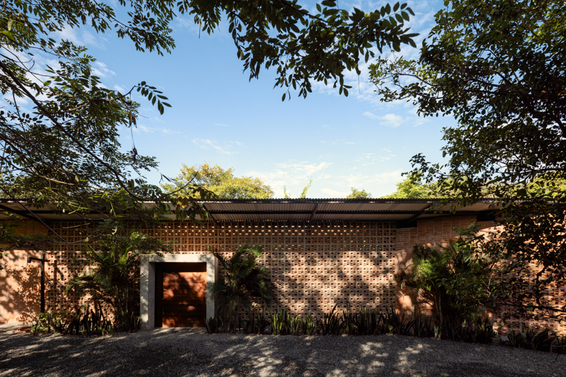 a series of porous brick partitions enclose central garden within costa rica residence
